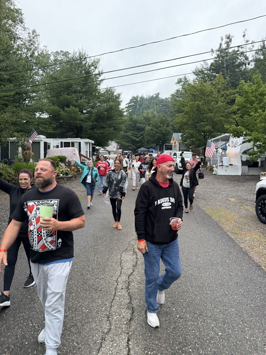 A crowd of friends parading through the Paugus Bay campground