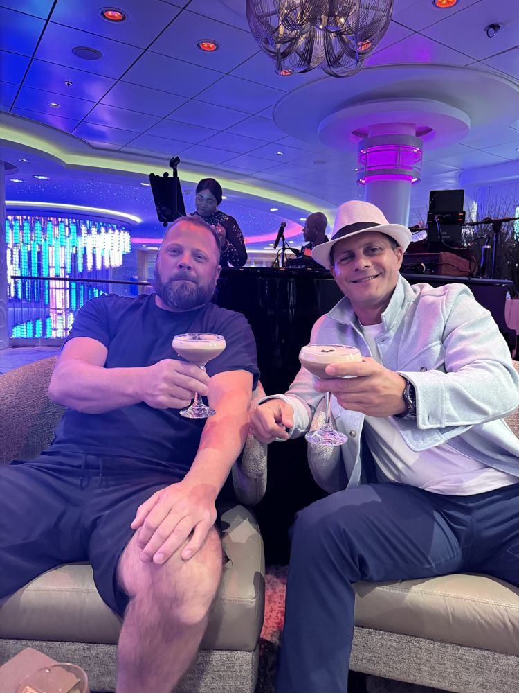 Rob and a friend toasting espresso martinis on a cruise ship