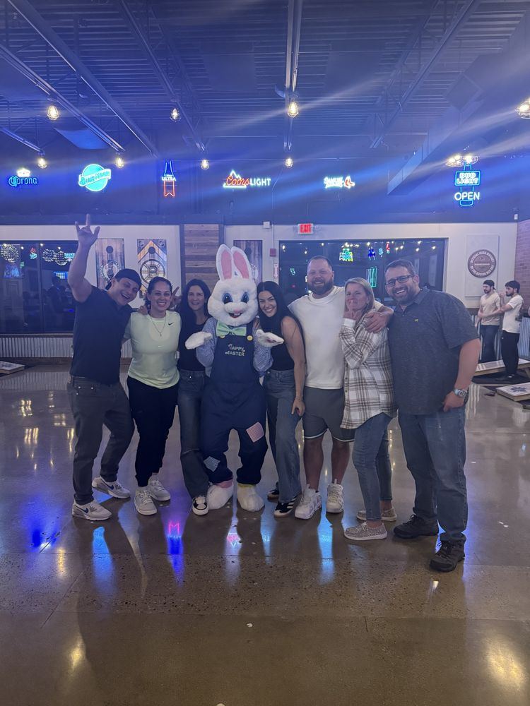 Rob and friends posing with the Easter bunny at a bar