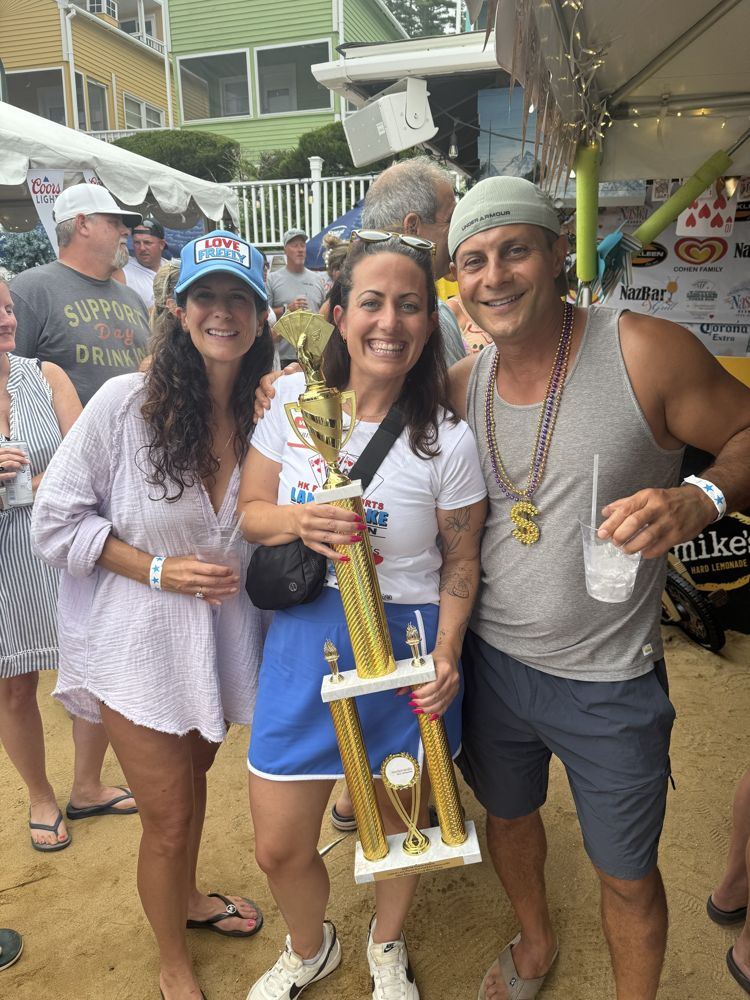 Rob with friends and a trophy at the lake poker run