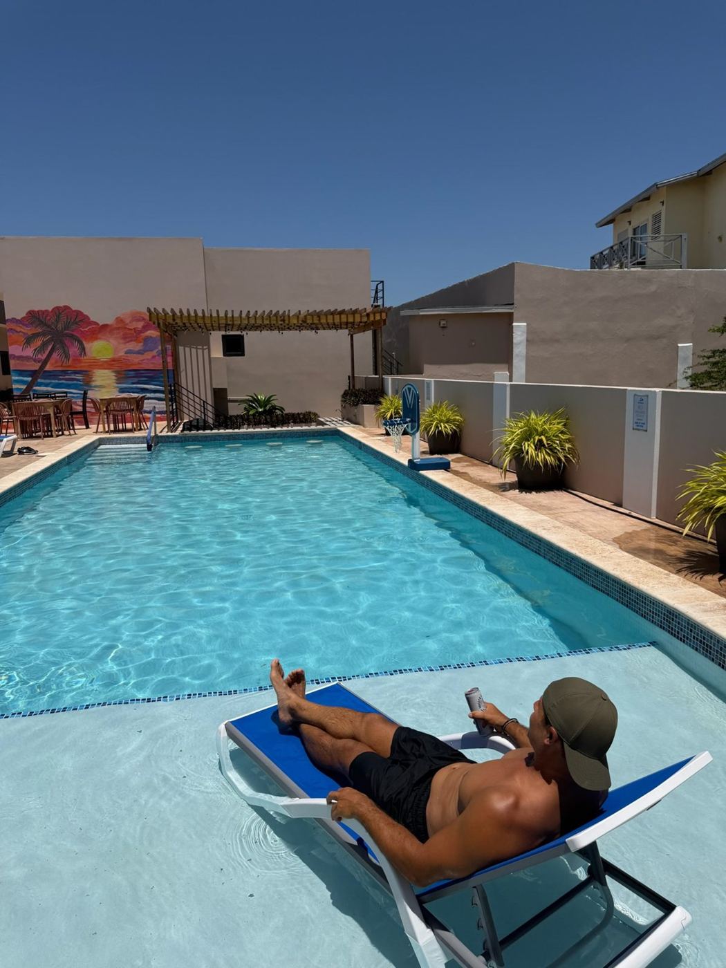 Rob relaxing on a lounger in the shallow end of a villa pool